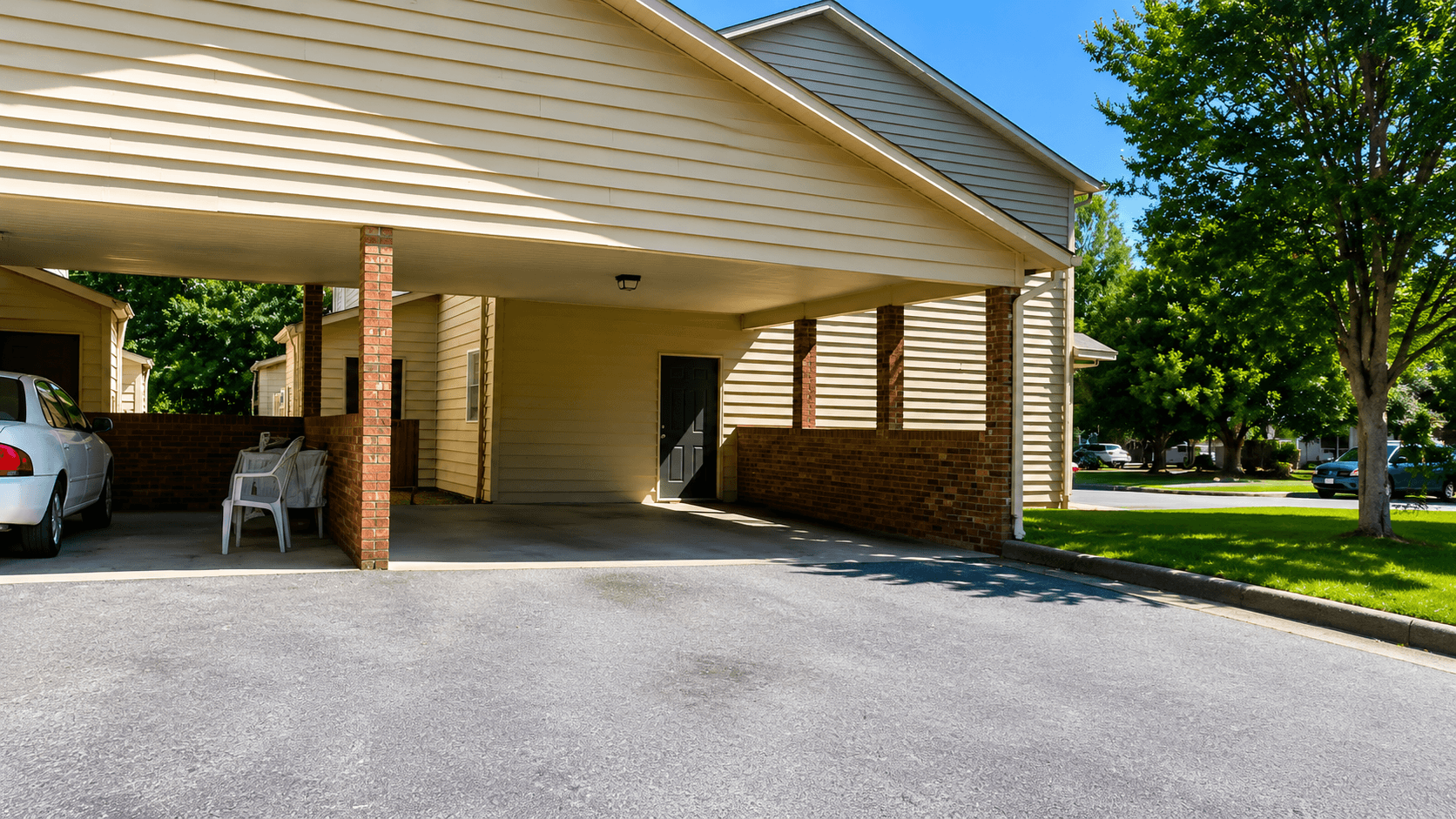 A house with a garage and a car parked in front.